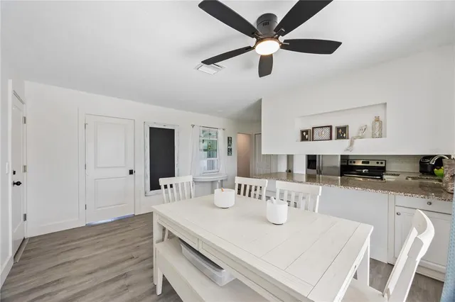 a view of a kitchen with dining table and chairs