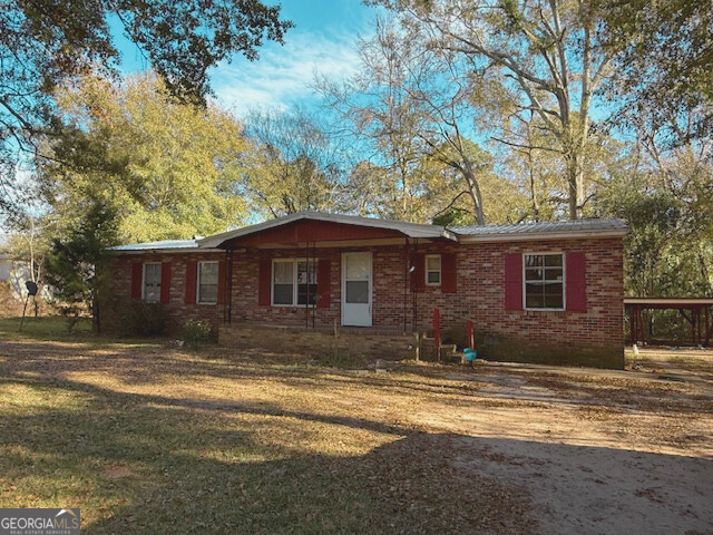138 Deacon J Simmons Road Southwest Milledgeville, GA 31061 - Photo 1 of 11 a view of a house with a yard covered with snow