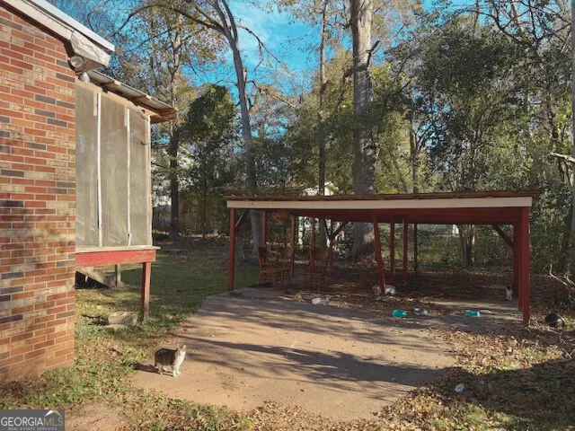 a view of a chair and table in the patio