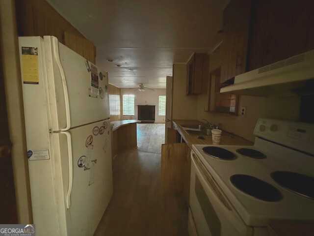 138 Deacon J Simmons Road Southwest Milledgeville, GA 31061 - Photo 7 of 11 a kitchen with stainless steel appliances granite countertop a refrigerator and a sink