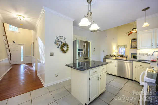 a kitchen with a cabinets and chandelier