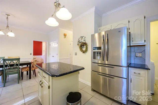 a kitchen with stainless steel appliances granite countertop a refrigerator a stove a sink and a refrigerator