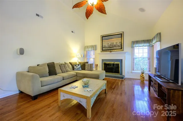 a living room with furniture fireplace and flat screen tv
