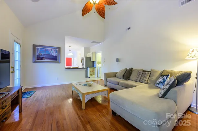 a living room with furniture and wooden floor