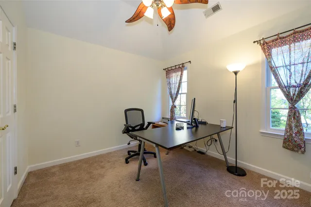 a view of a workspace with a window and couch