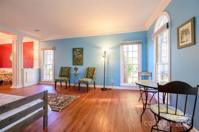 a living room with furniture and a wooden floor