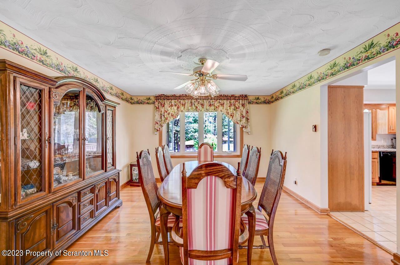 3 T-338 Moscow, PA 18444 - Photo 13 of 62 a dining room with furniture a chandelier and wooden floor