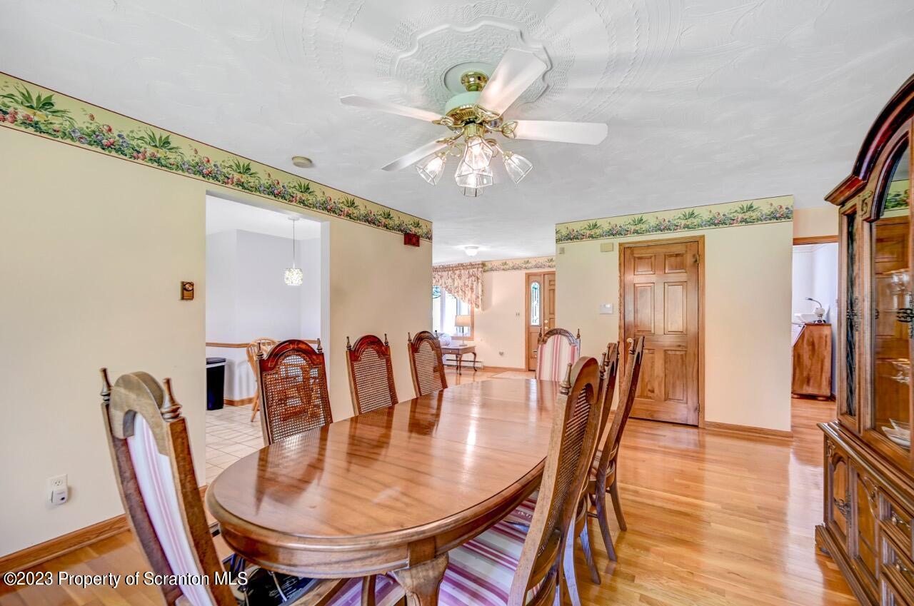 3 T-338 Moscow, PA 18444 - Photo 15 of 62 a dining room with furniture a chandelier and wooden floor