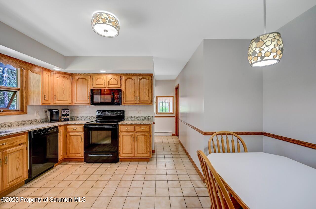 3 T-338 Moscow, PA 18444 - Photo 17 of 62 a kitchen with stainless steel appliances granite countertop a stove top oven a sink a counter space and cabinets