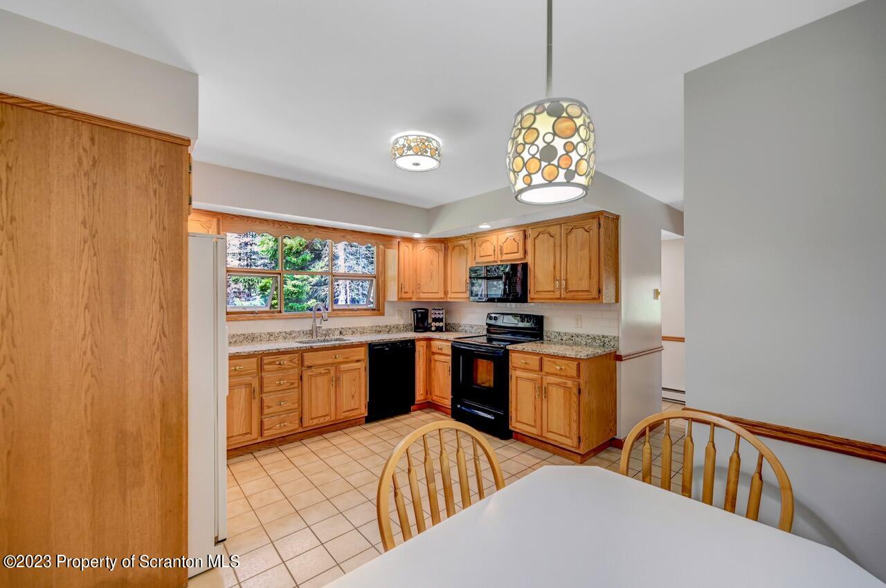 3 T-338 Moscow, PA 18444 - Photo 18 of 62 a kitchen with stainless steel appliances granite countertop a sink stove and refrigerator