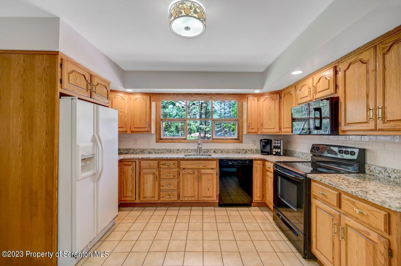 3 T-338 Moscow, PA 18444 - Photo 20 of 62 a kitchen with stainless steel appliances granite countertop a stove sink and refrigerator