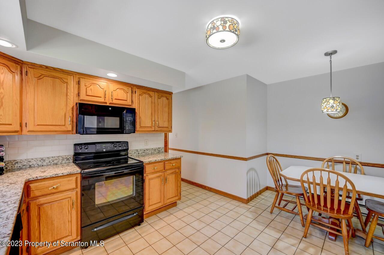 3 T-338 Moscow, PA 18444 - Photo 23 of 62 a kitchen with stainless steel appliances granite countertop a stove a sink and a microwave