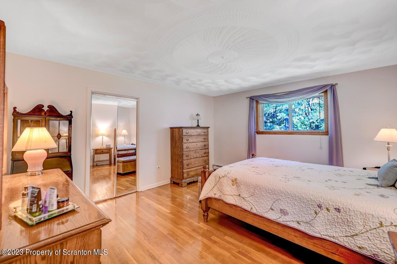 3 T-338 Moscow, PA 18444 - Photo 26 of 62 a bedroom with a bed and wooden floor