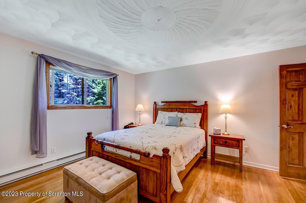3 T-338 Moscow, PA 18444 - Photo 27 of 62 a bedroom with a bed and a dresser next to a window