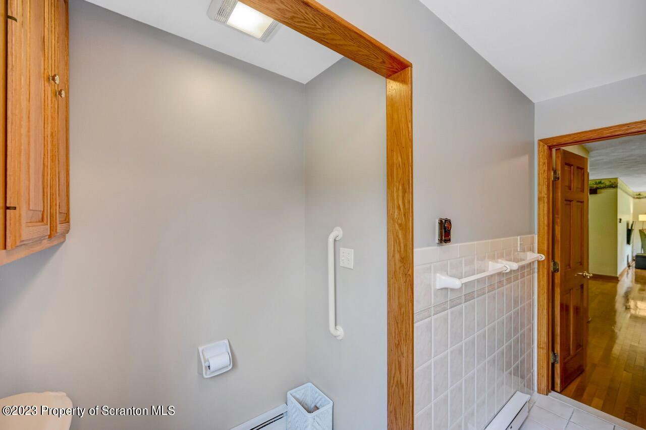 3 T-338 Moscow, PA 18444 - Photo 31 of 62 a bathroom with a granite countertop sink and a mirror