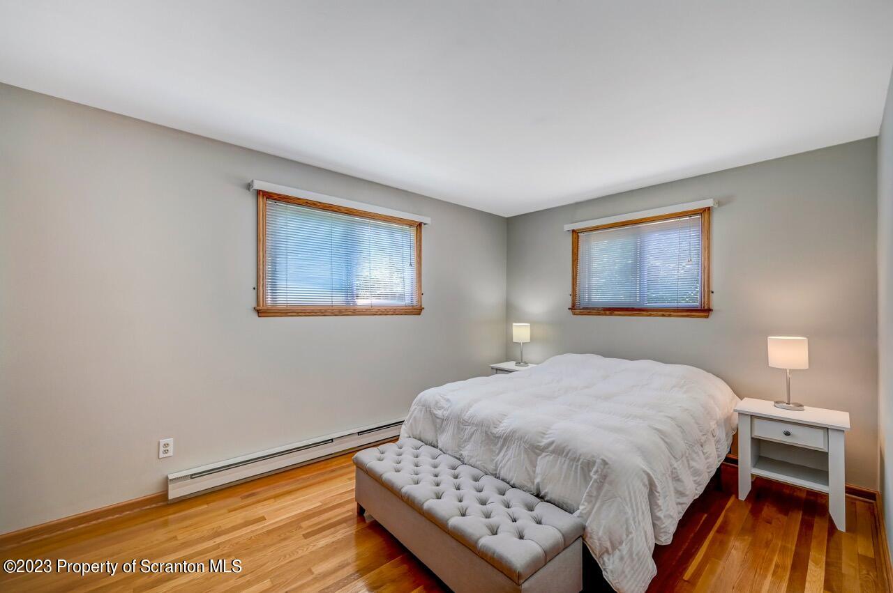 3 T-338 Moscow, PA 18444 - Photo 32 of 62 a bedroom with a bed and a night stand