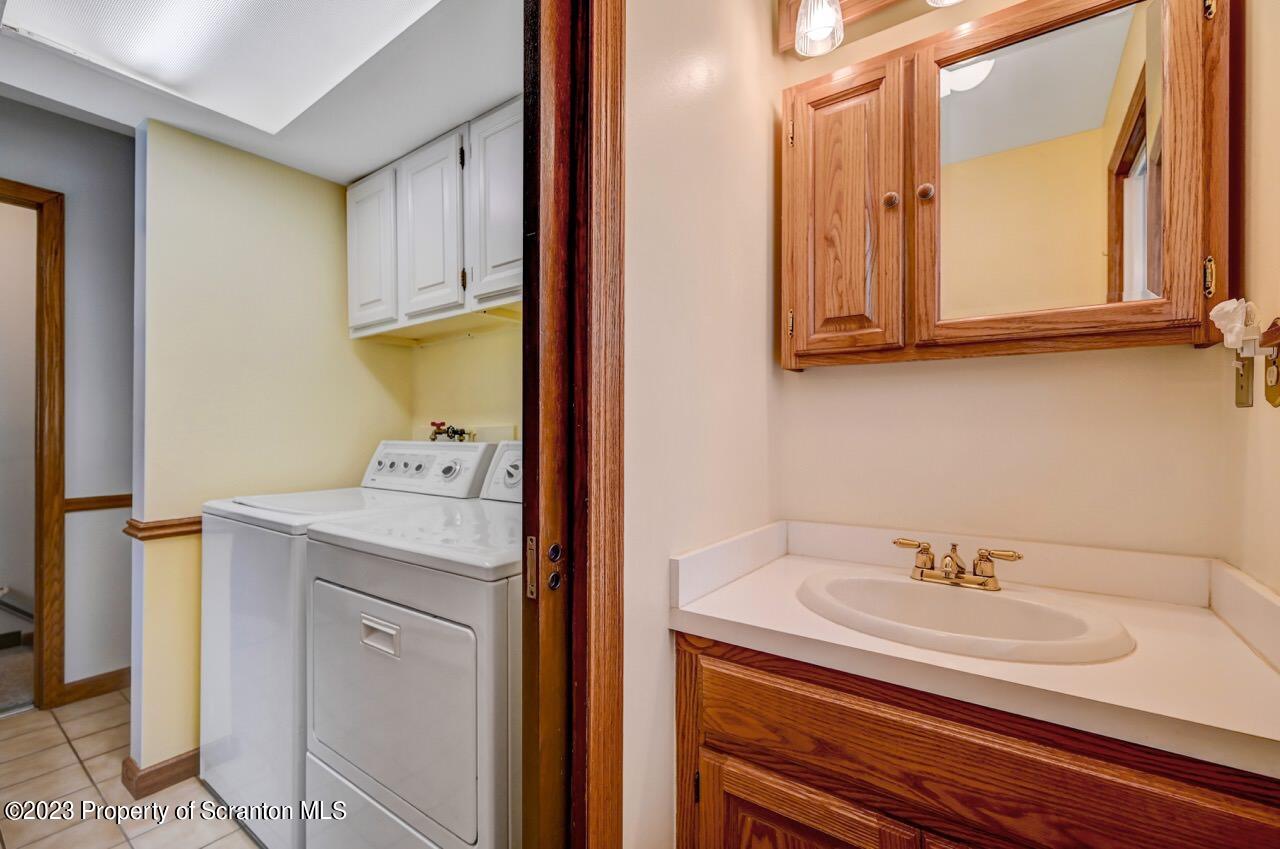 3 T-338 Moscow, PA 18444 - Photo 39 of 62 a bathroom with a sink and a mirror