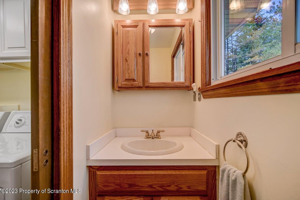 3 T-338 Moscow, PA 18444 - Photo 40 of 62 a bathroom with a sink and a mirror