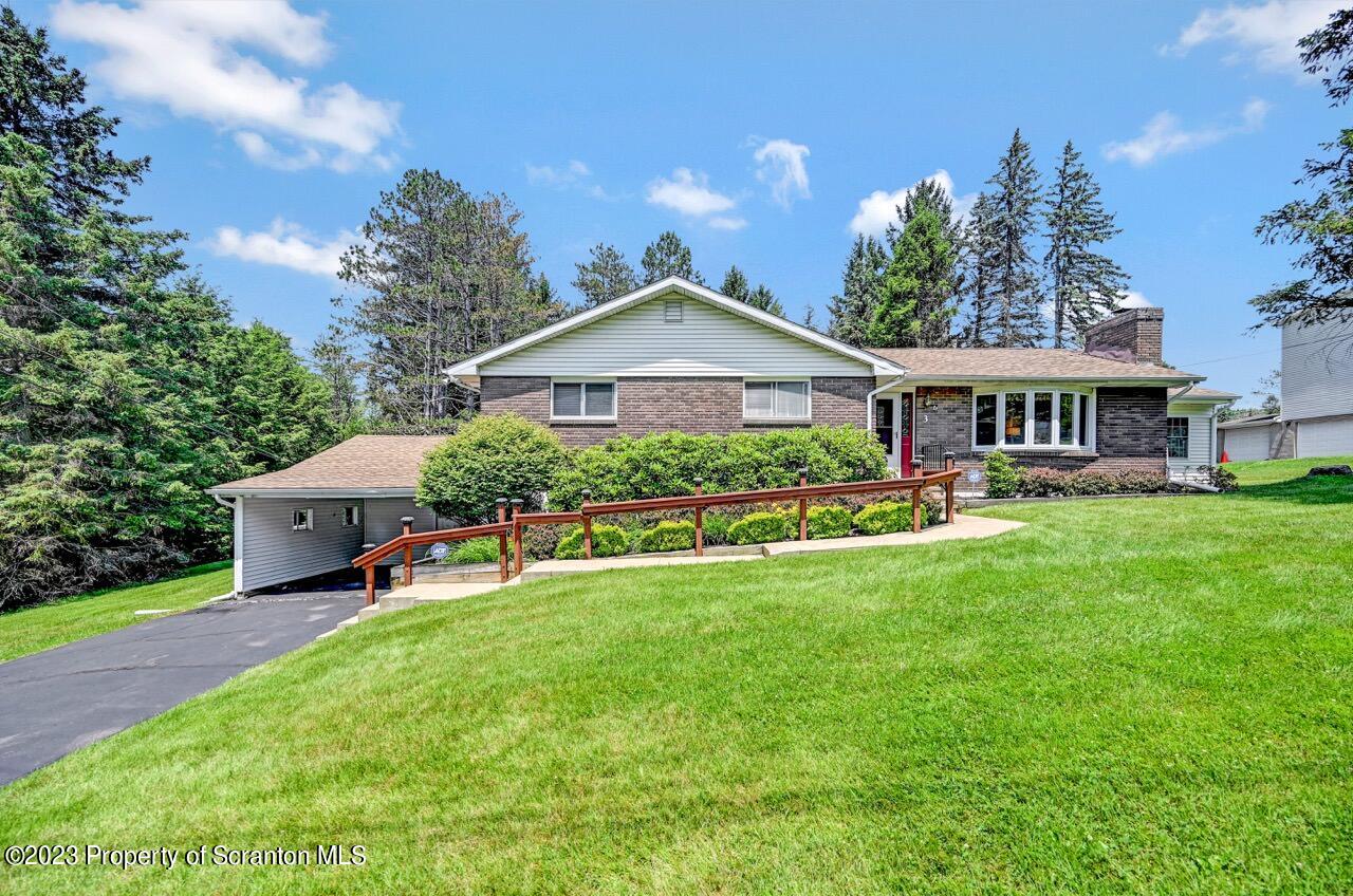3 T-338 Moscow, PA 18444 - Photo 58 of 62 a front view of a house with a yard table and chairs