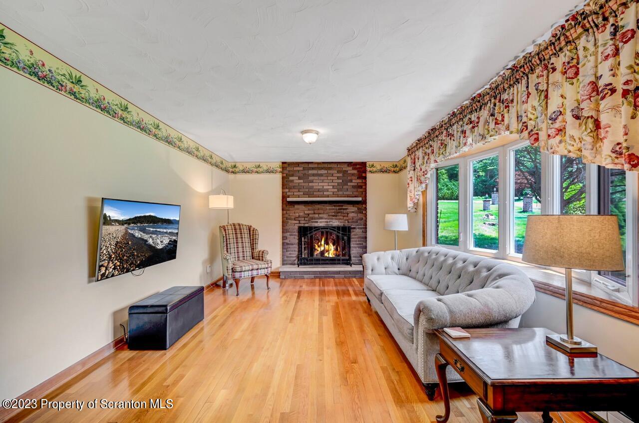3 T-338 Moscow, PA 18444 - Photo 7 of 62 a living room with furniture and a fireplace