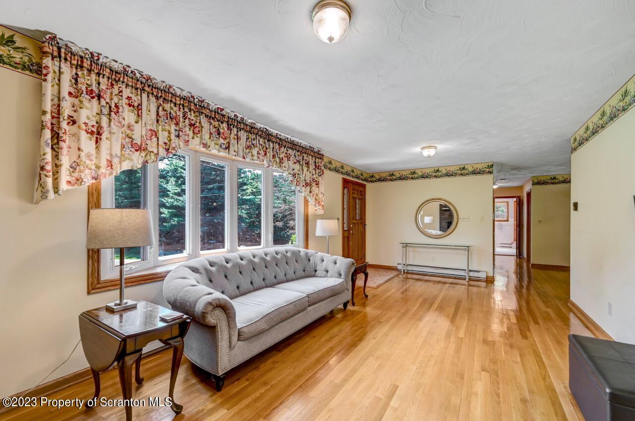 3 T-338 Moscow, PA 18444 - Photo 9 of 62 a living room with a couch and a table with wooden floor