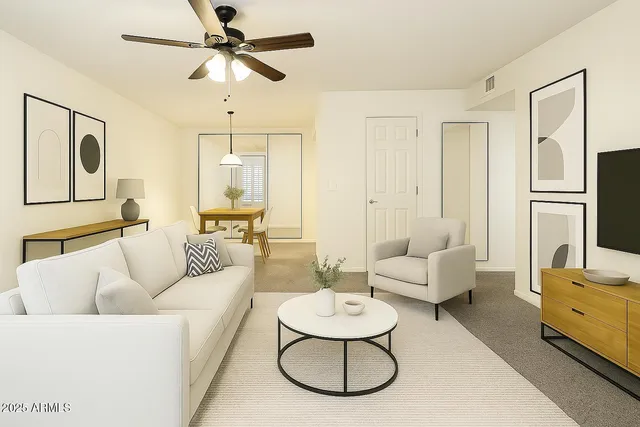 a living room with furniture and a chandelier
