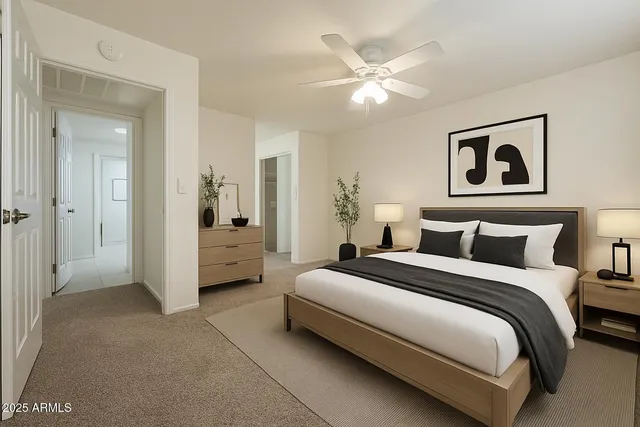 a spacious bedroom with a bed and a chandelier