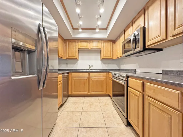a kitchen with stainless steel appliances granite countertop a sink and cabinets