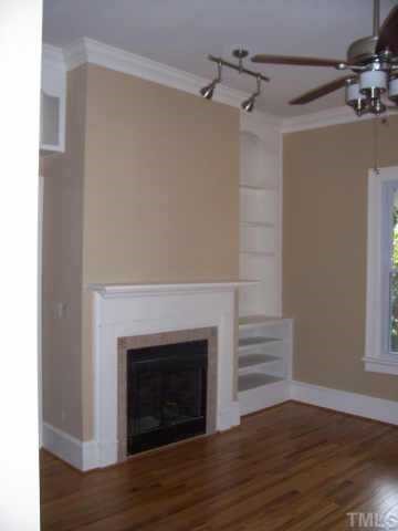 726 Gaston Street Raleigh, NC 27605 - Photo 2 of 9 Living room with new hardwood floors, gas-log fireplace and built-ins.