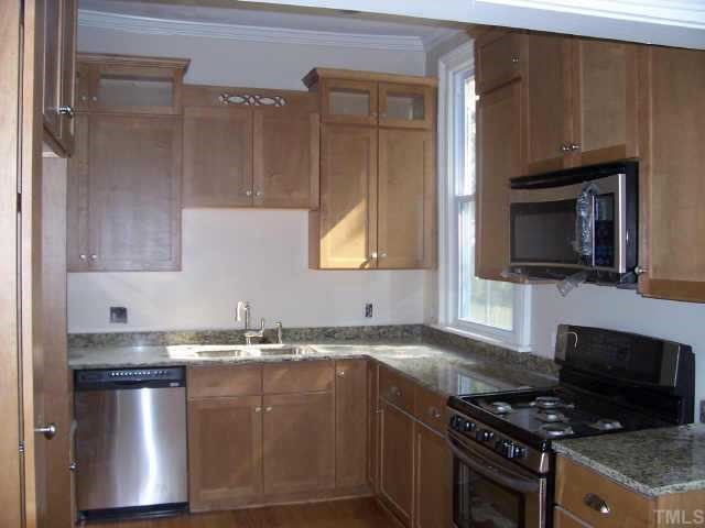 726 Gaston Street Raleigh, NC 27605 - Photo 4 of 9 Gorgeous new kitchen includes ample cabinet space, dual-fuel range and granite countertops.