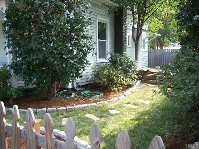 726 Gaston Street Raleigh, NC 27605 - Photo 7 of 9 Side yard landscape has a stepping stone path and granite block edging.