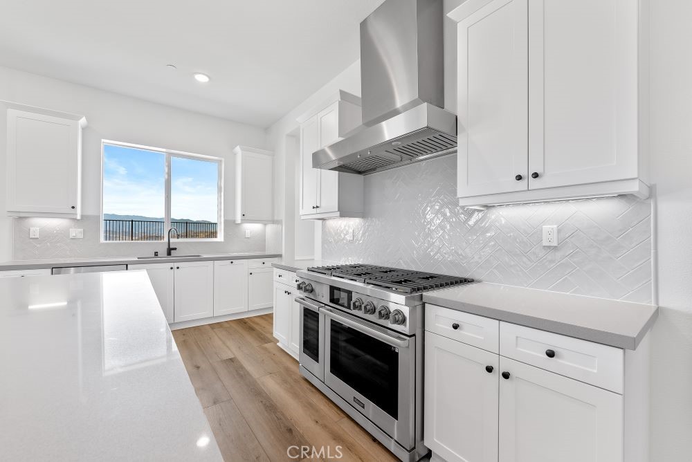 29818 Old Ranch Circle Castaic, CA 91384 - Photo 12 of 41 a kitchen with stainless steel appliances white cabinets and a granite counter tops