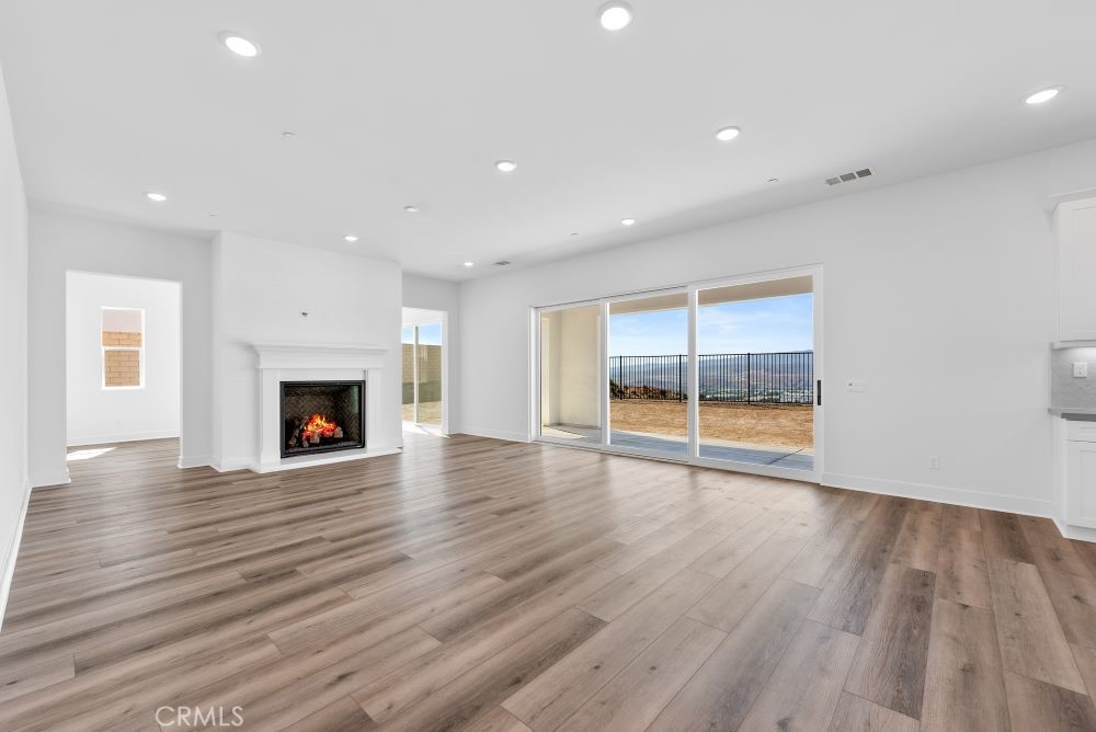 29818 Old Ranch Circle Castaic, CA 91384 - Photo 15 of 41 a view of empty room with wooden floor and fireplace