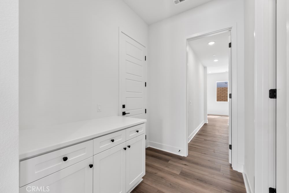 29818 Old Ranch Circle Castaic, CA 91384 - Photo 19 of 41 a view of a hallway with wooden floor