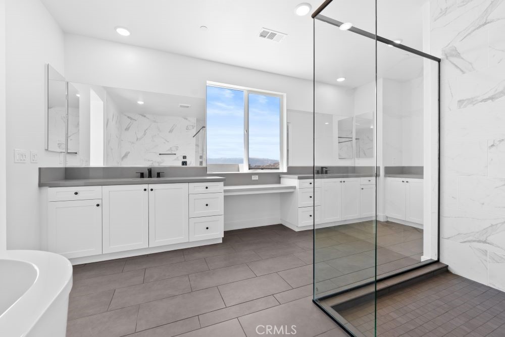 29818 Old Ranch Circle Castaic, CA 91384 - Photo 26 of 41 a kitchen with a refrigerator a sink and cabinets