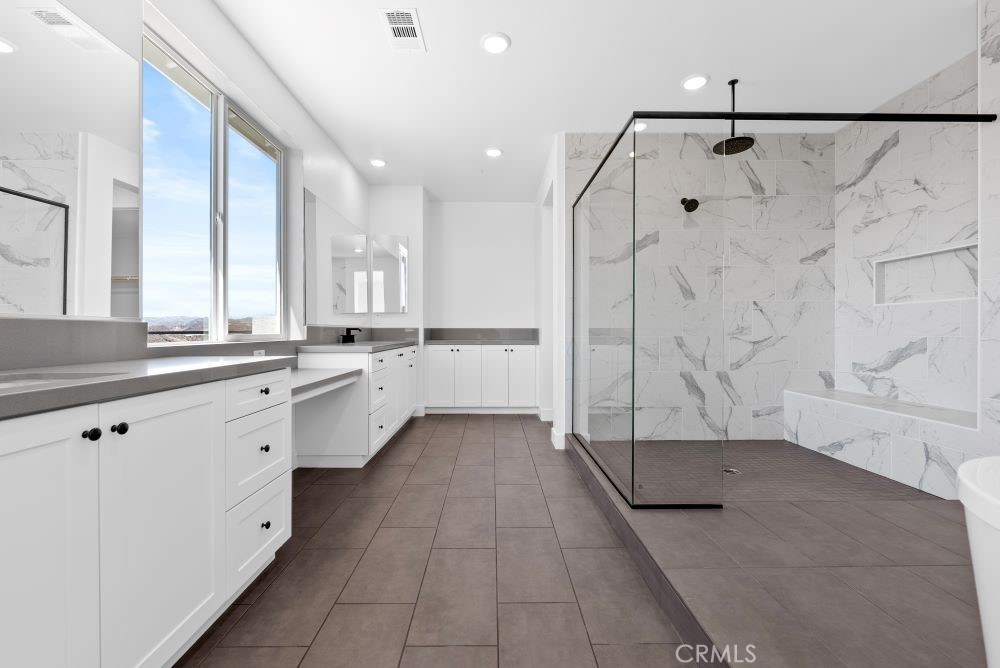 29818 Old Ranch Circle Castaic, CA 91384 - Photo 27 of 41 a large white bathroom with a double vanity sink a mirror and a shower