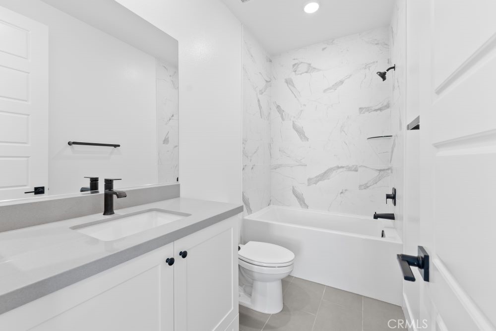 29818 Old Ranch Circle Castaic, CA 91384 - Photo 33 of 41 a bathroom with a granite countertop sink a toilet and a bathtub