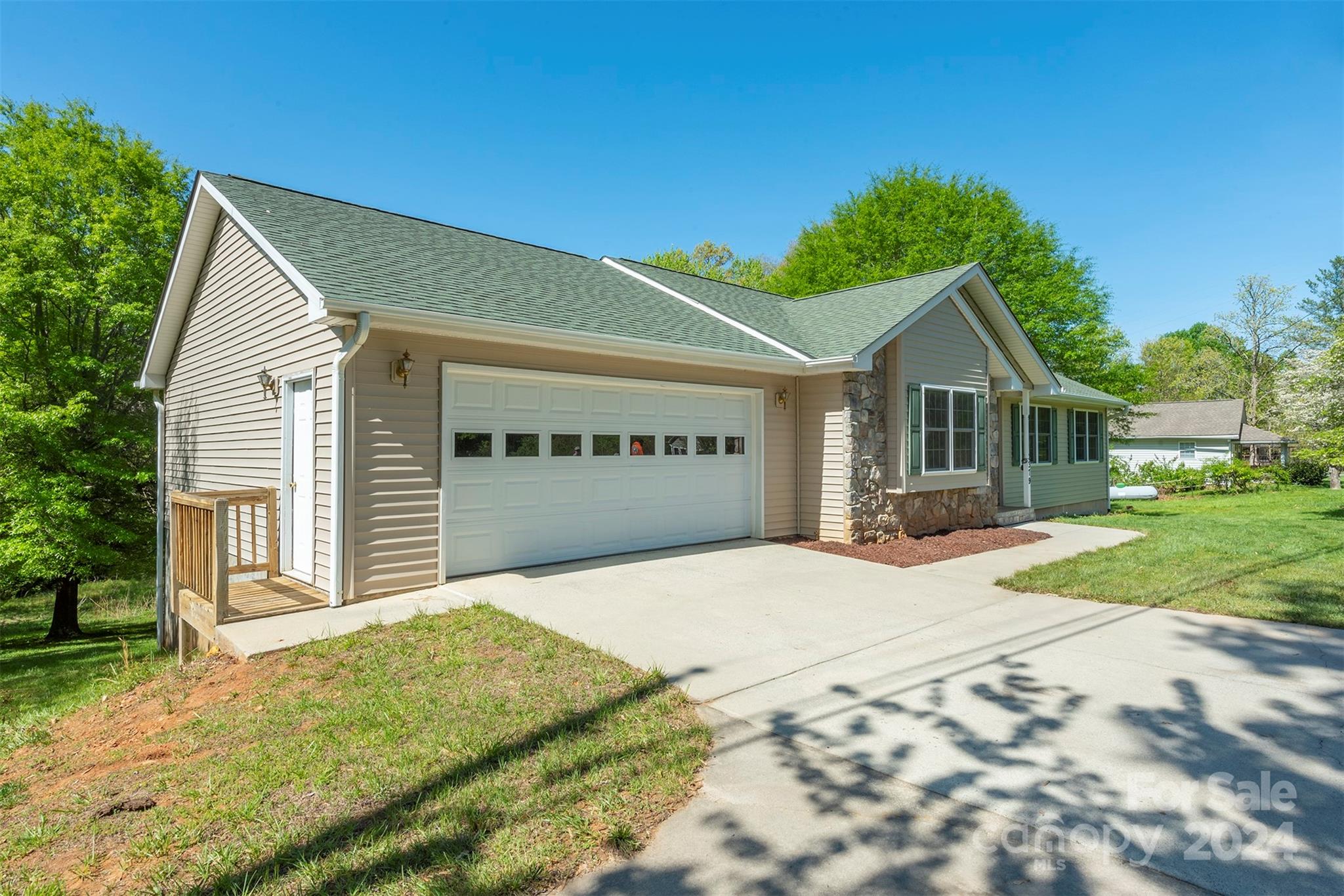 379 Buckeye Cove Road Swannanoa, NC 28778 - Photo 1 of 31 a front view of a house with a yard and garage