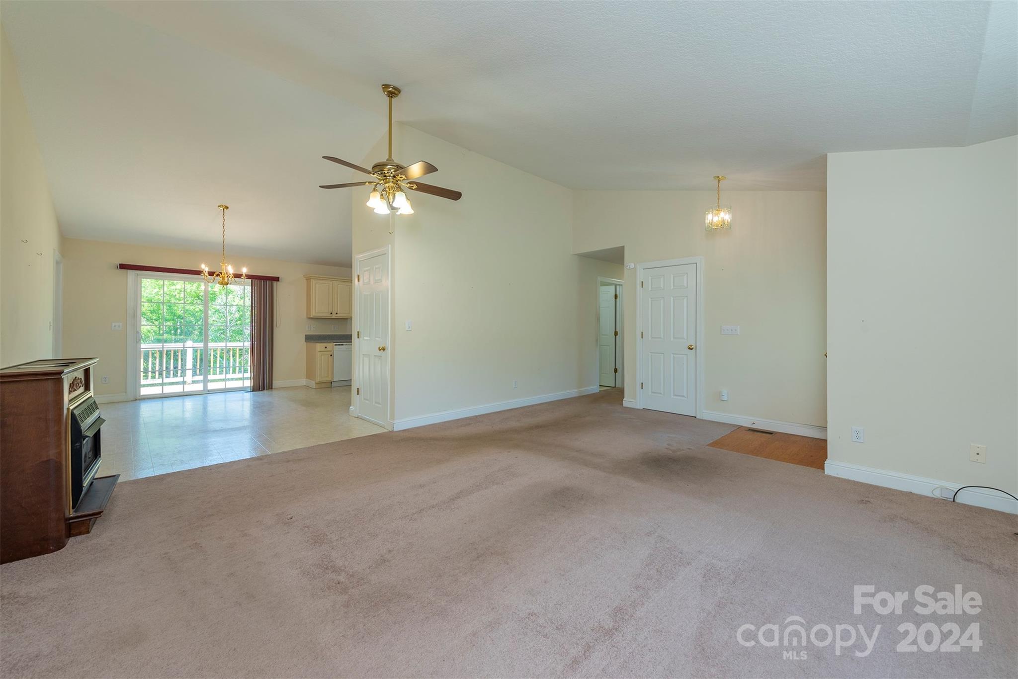 379 Buckeye Cove Road Swannanoa, NC 28778 - Photo 11 of 31 an empty room with chandelier fan and windows