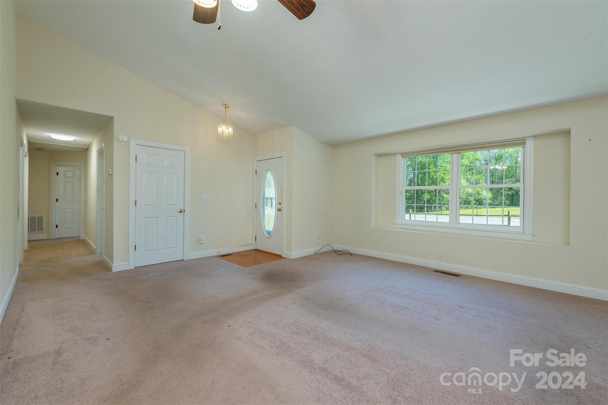 379 Buckeye Cove Road Swannanoa, NC 28778 - Photo 13 of 31 an empty room with windows and chandelier fan