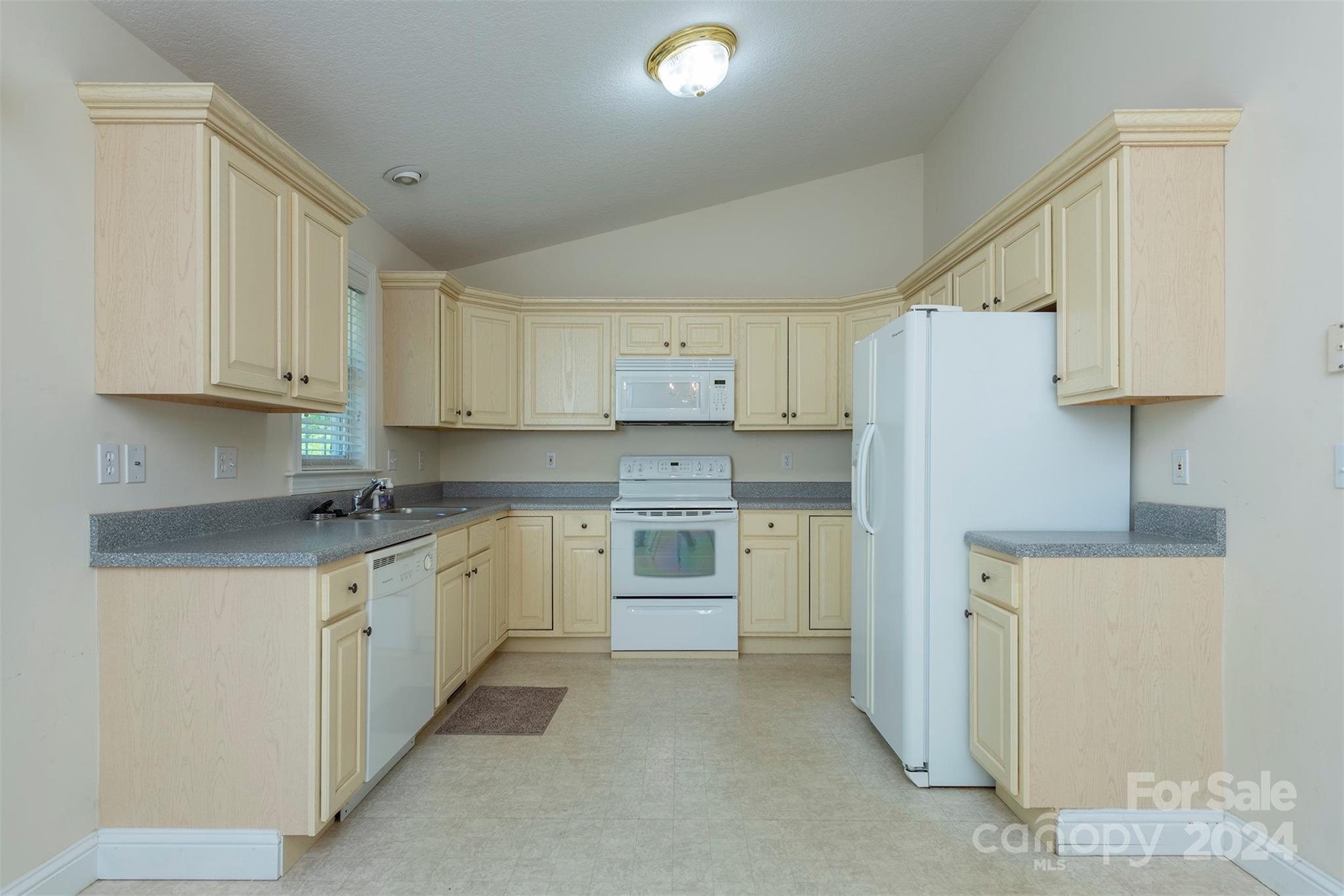 379 Buckeye Cove Road Swannanoa, NC 28778 - Photo 6 of 31 a kitchen with white cabinets and white appliances