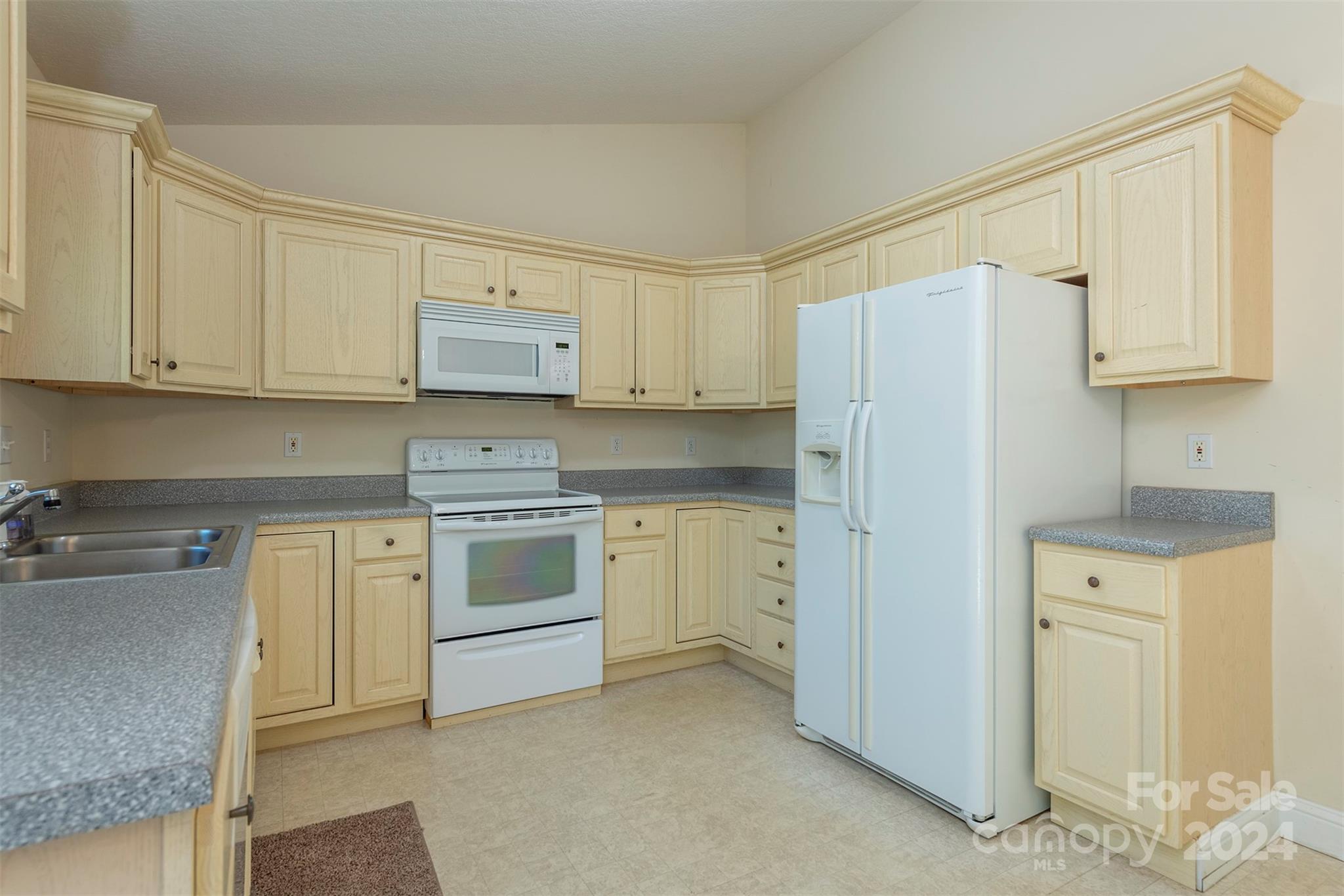 379 Buckeye Cove Road Swannanoa, NC 28778 - Photo 7 of 31 a kitchen with white cabinets and white appliances