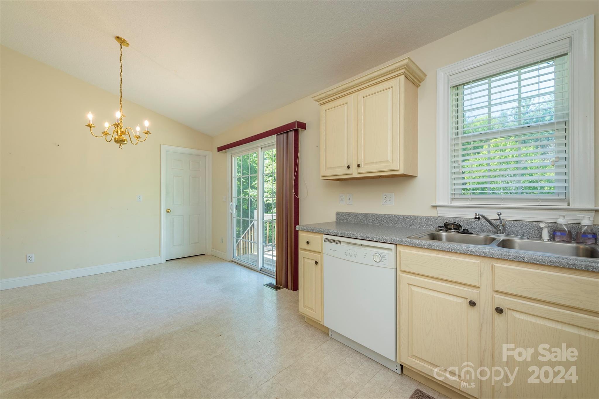 379 Buckeye Cove Road Swannanoa, NC 28778 - Photo 8 of 31 a kitchen with granite countertop white cabinets and window