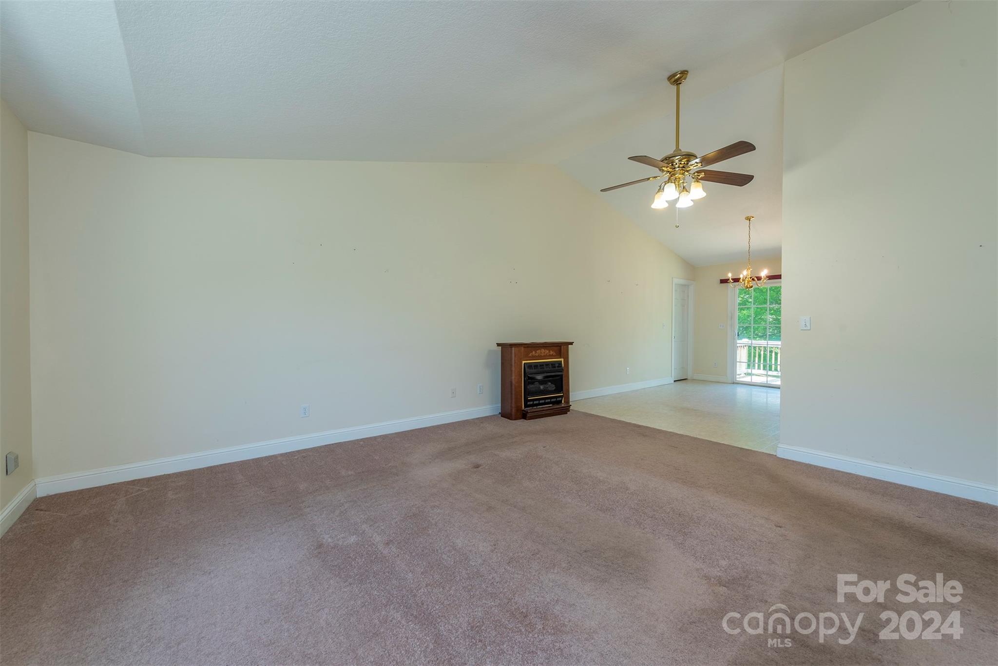 379 Buckeye Cove Road Swannanoa, NC 28778 - Photo 10 of 31 an empty room with windows and ceiling fan