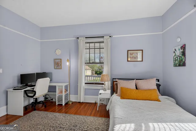 a bedroom with a bed dresser and a window