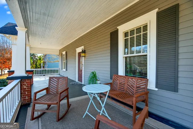 a balcony with furniture and a potted plant