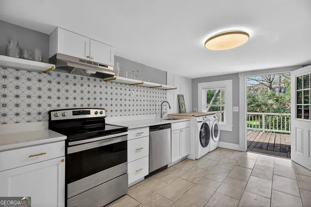 a kitchen with sink and cabinets