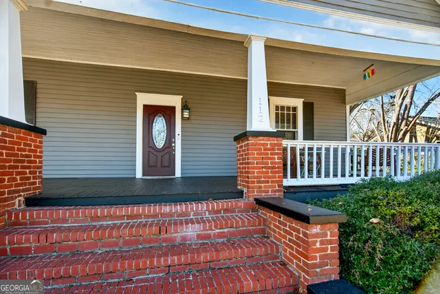 a view of a patio with couches table and chairs and potted plants