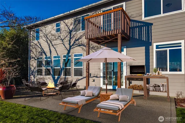a view of a patio with a table and chairs under an umbrella