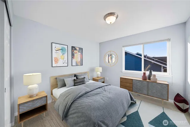 a bedroom with a bed and a painting on the wall